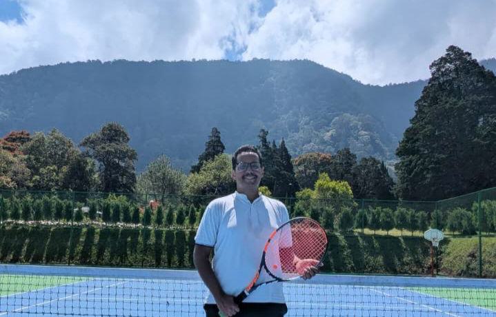 Fawwaz Alharbi on a tennis court, holding his racket